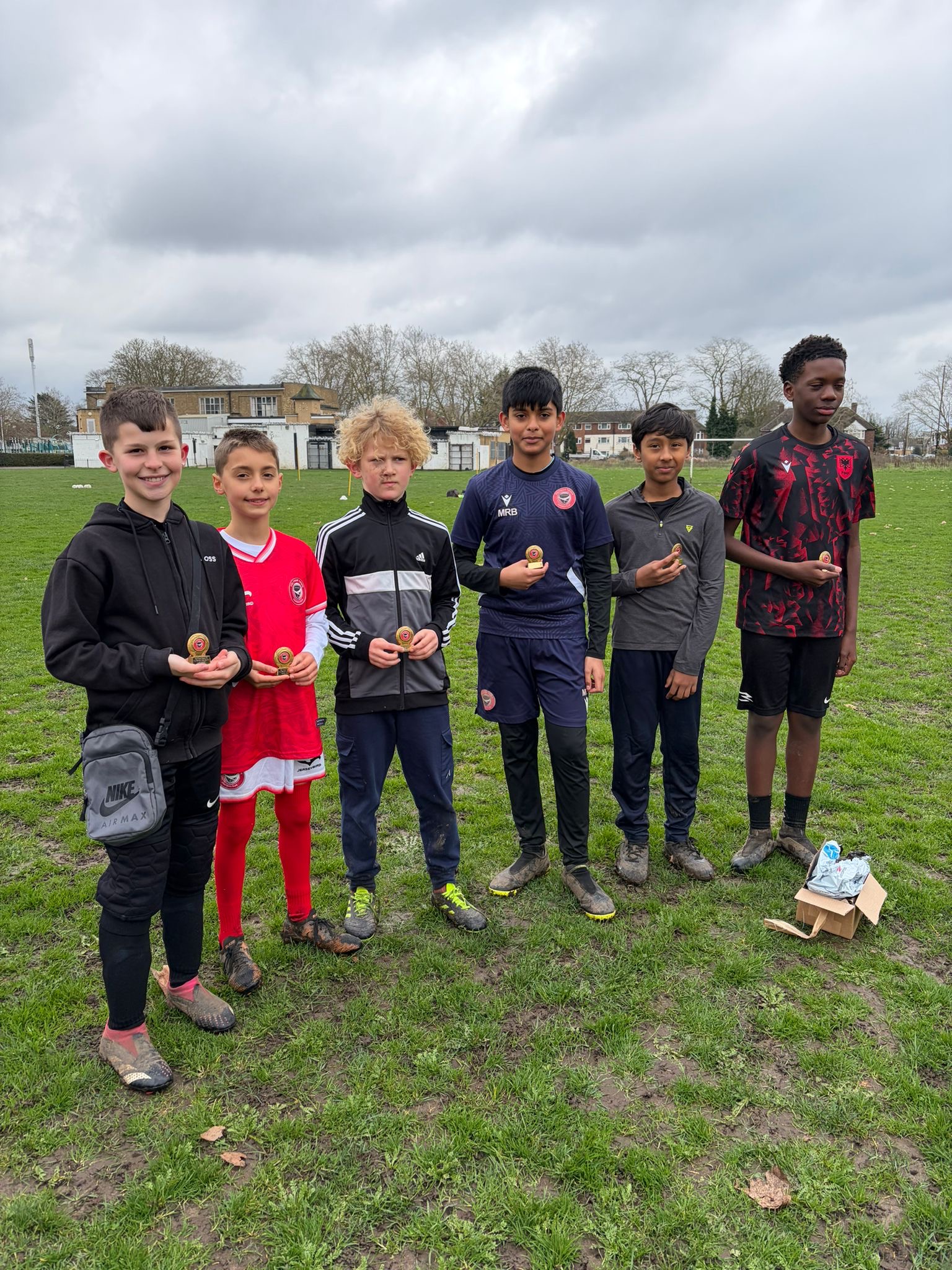 Young Feltham Town FC players lined up with their shirts
